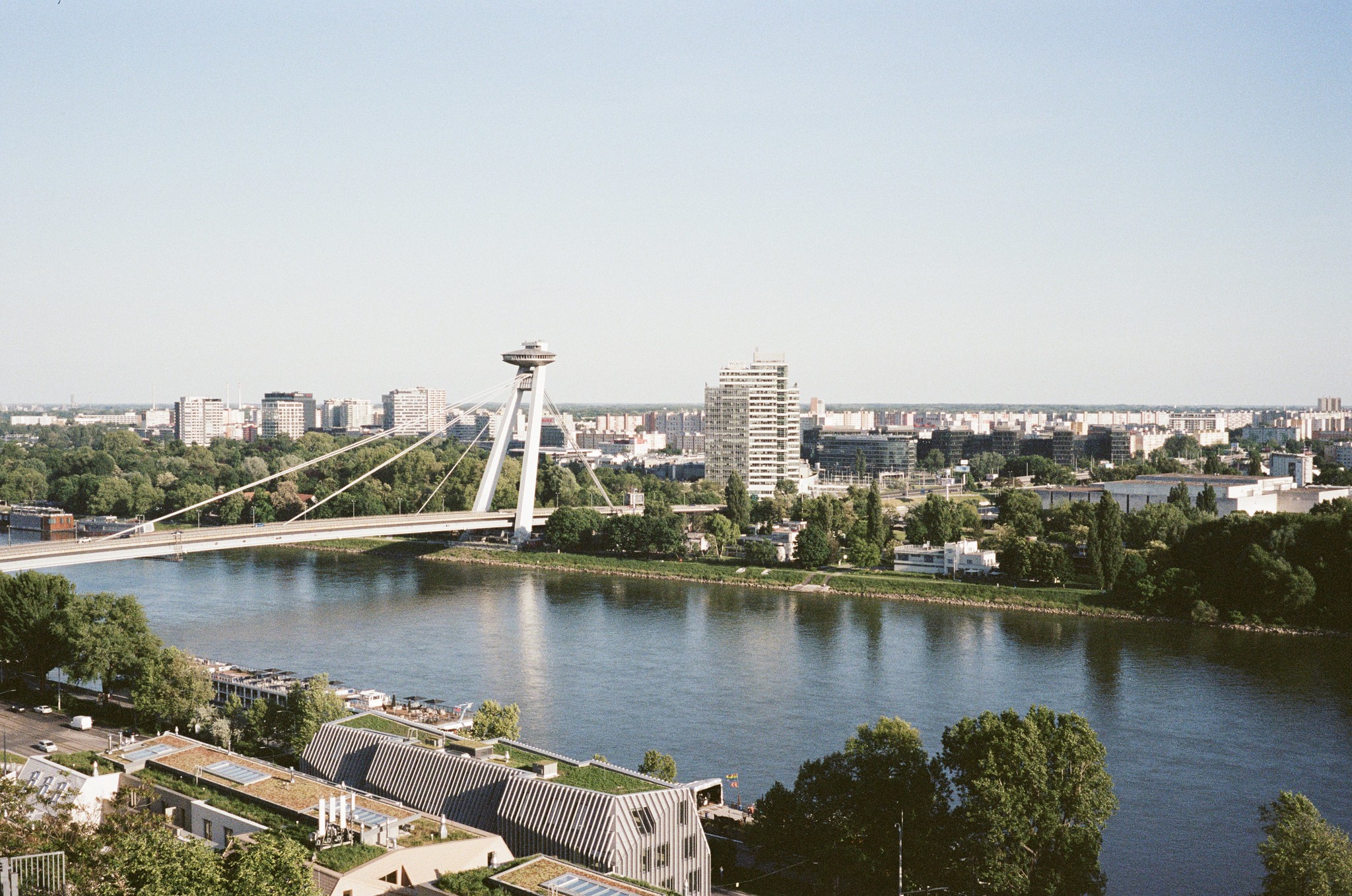 View of the edge of Bratislava city centre. A futuristic bridge directs traffic from the outskirts of the city directly into the centre of the old town.